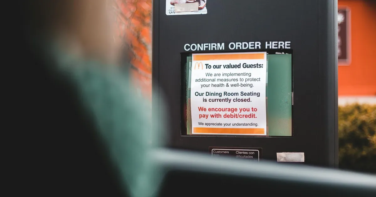 Restaurant owner reviewing failed health inspection report at desk