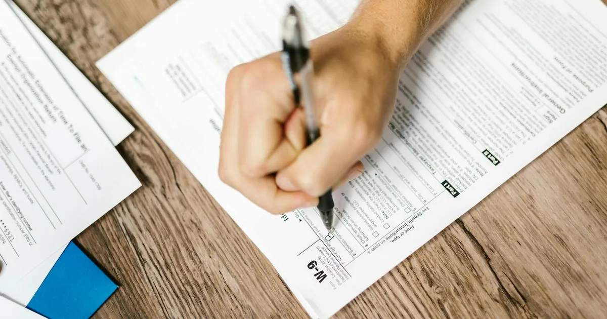 Restaurant manager reviewing compliance documents and budget spreadsheets at a desk