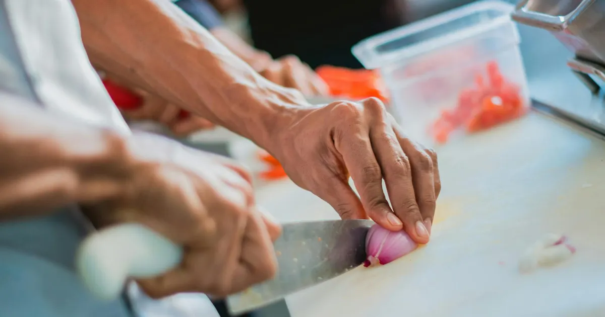 Restaurant kitchen staff performing food safety temperature checks during service