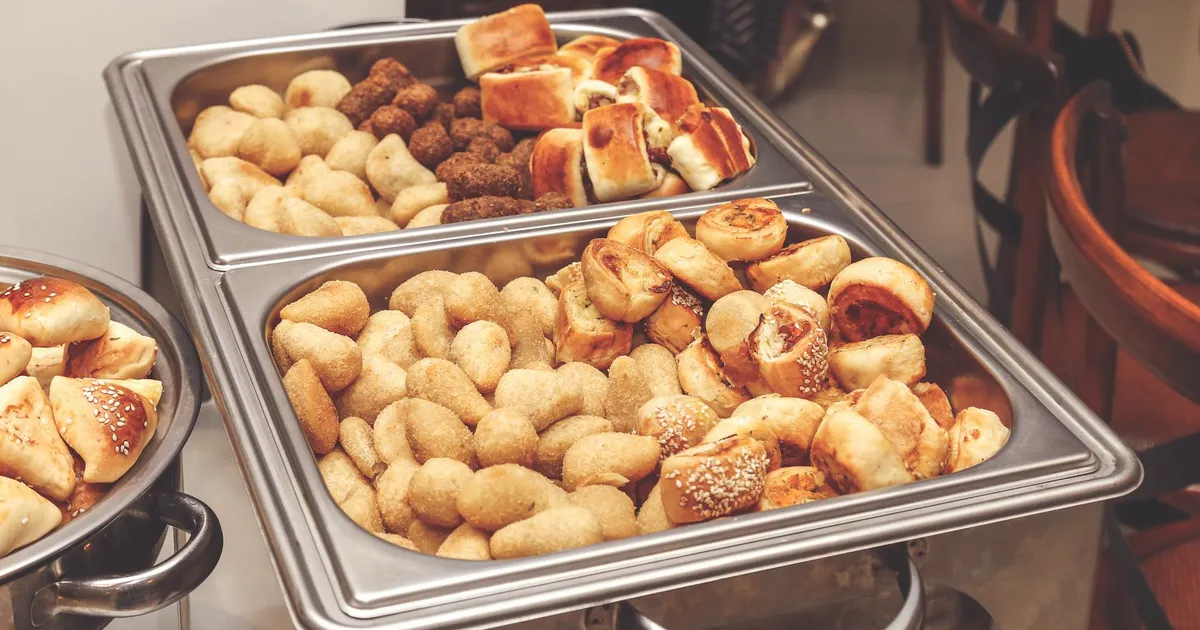 Holiday catering setup with professional food service equipment maintaining proper food temperatures at an event