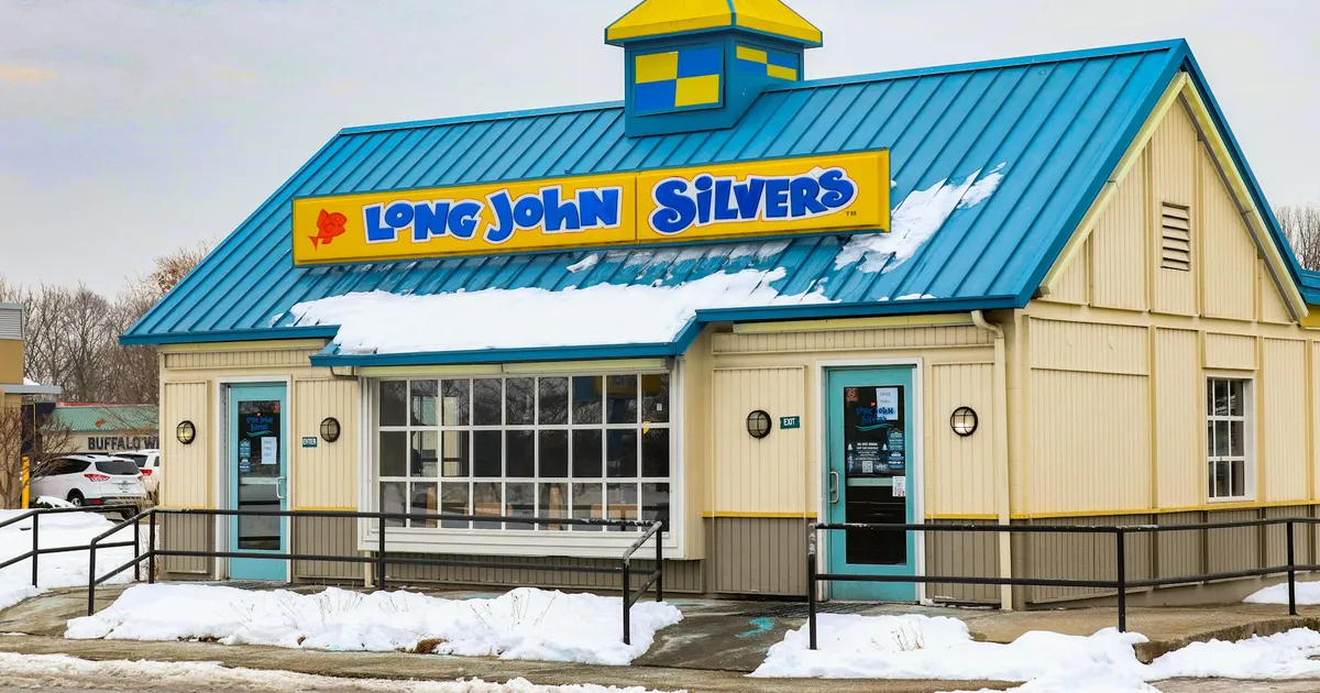 Restaurant group operations manager reviewing food safety compliance data across multiple locations on dashboard