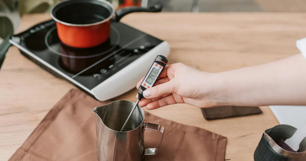 Various food thermometers laid out on a commercial kitchen counter