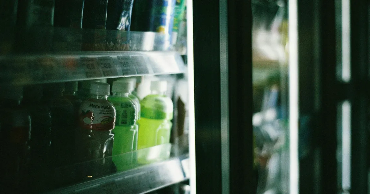 Commercial walk-in cooler with organized shelves and temperature monitoring display